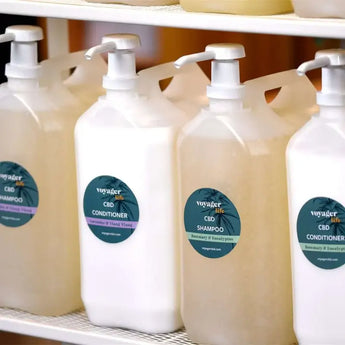 CBD shampoo refillery pump action containers lined up on a shelf 